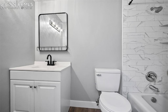 full bathroom featuring hardwood / wood-style floors, vanity, toilet, and tiled shower / bath