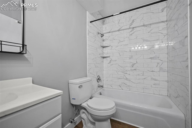 full bathroom with vanity, tiled shower / bath combo, and toilet