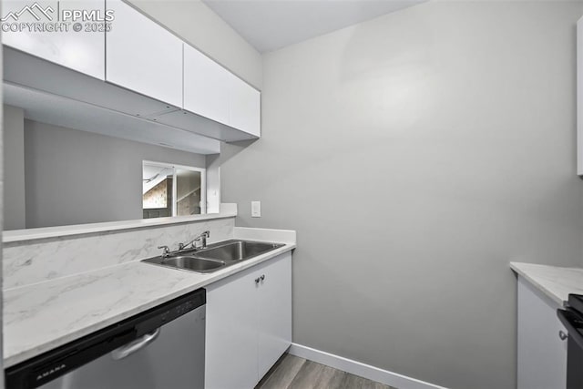 kitchen featuring white cabinetry, dishwasher, dark wood-type flooring, and sink