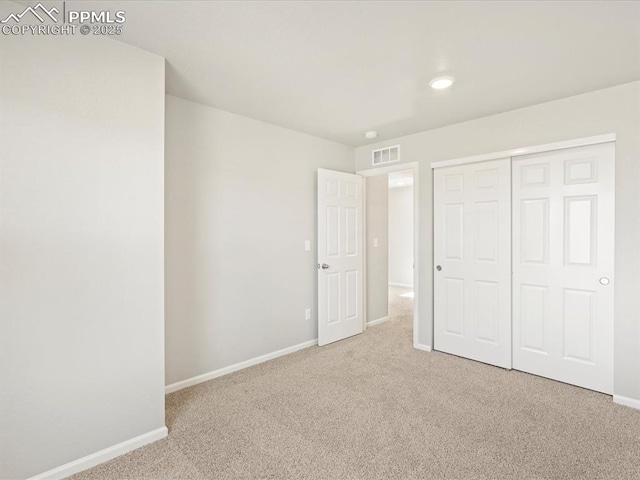 unfurnished bedroom featuring carpet flooring and a closet