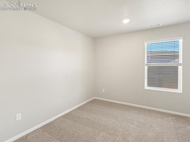 unfurnished room with carpet flooring