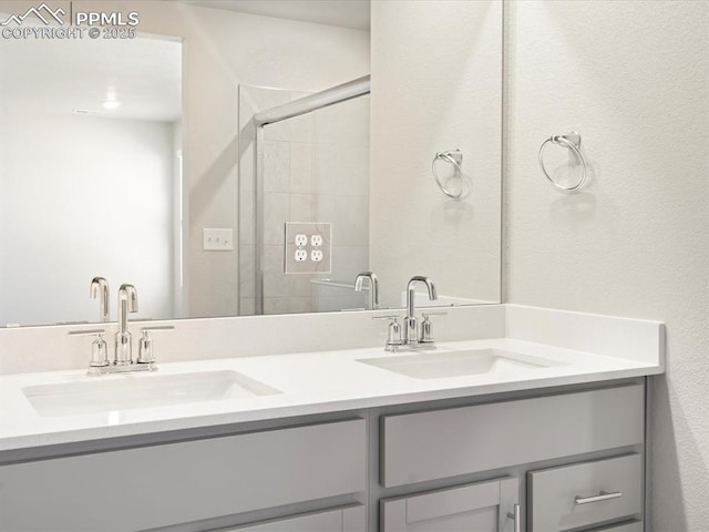 bathroom with vanity and a shower with shower door