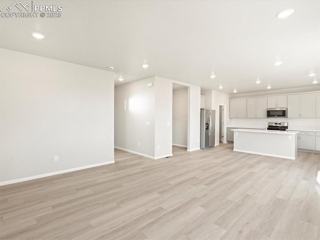 unfurnished living room with light hardwood / wood-style flooring