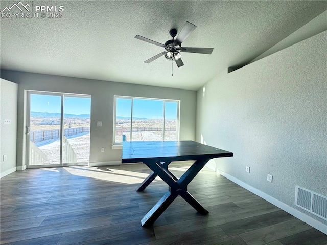 unfurnished dining area with dark hardwood / wood-style flooring, ceiling fan, and a wealth of natural light