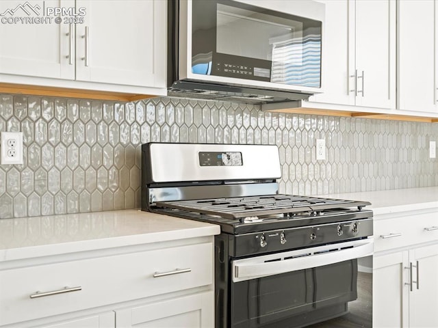 kitchen featuring appliances with stainless steel finishes, white cabinets, light countertops, and backsplash