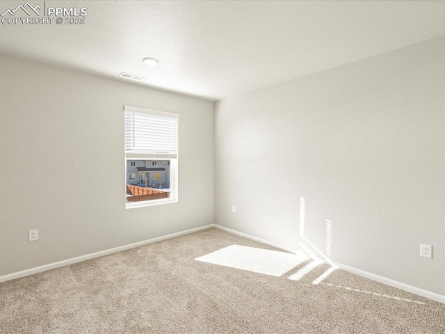 carpeted empty room with visible vents and baseboards