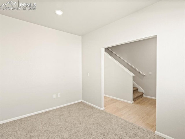 carpeted spare room with stairs, recessed lighting, and baseboards