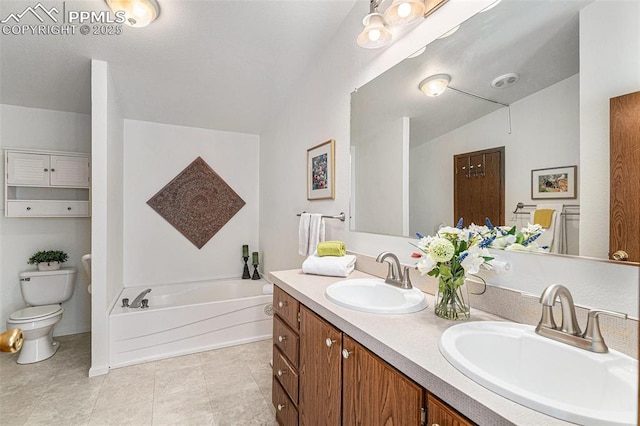 bathroom featuring a bathing tub, vaulted ceiling, vanity, and toilet