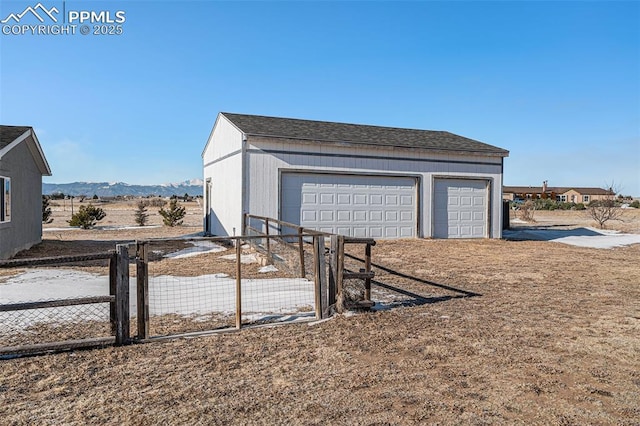 view of outbuilding featuring a garage and a mountain view