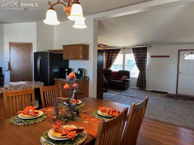 dining area with an inviting chandelier and hardwood / wood-style flooring