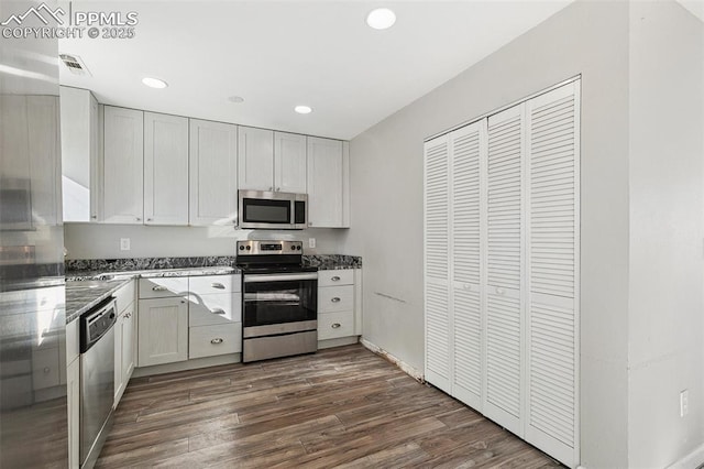 kitchen with white cabinets, dark hardwood / wood-style floors, and stainless steel appliances