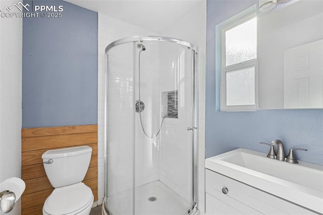 bathroom with toilet, an enclosed shower, and vanity