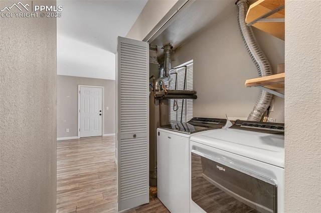 washroom featuring hardwood / wood-style floors and independent washer and dryer