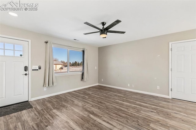 foyer entrance with hardwood / wood-style flooring and ceiling fan