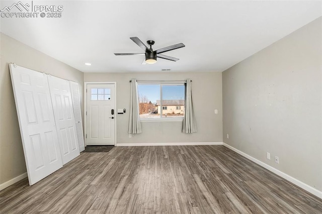 entrance foyer with ceiling fan and wood-type flooring