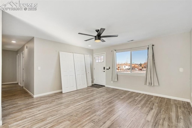 unfurnished bedroom featuring ceiling fan, a closet, and light hardwood / wood-style floors