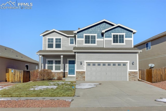 craftsman-style home with a front yard and a garage