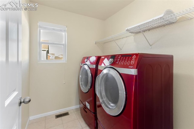 washroom featuring washer and dryer and light tile patterned floors