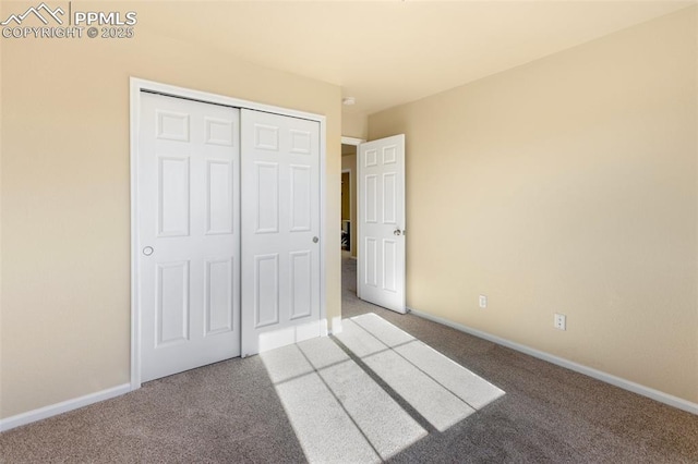 unfurnished bedroom featuring a closet and carpet floors