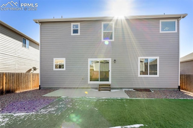 back of house with a lawn and a patio area