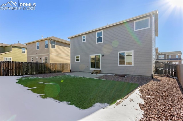 rear view of property with a patio and a lawn