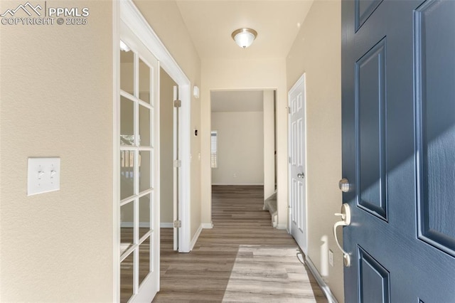 interior space with french doors and light wood-type flooring