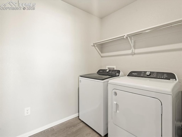 laundry room featuring washing machine and dryer and wood-type flooring