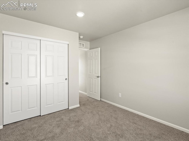 unfurnished bedroom featuring a closet and light carpet