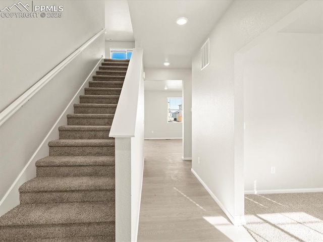 staircase featuring hardwood / wood-style floors