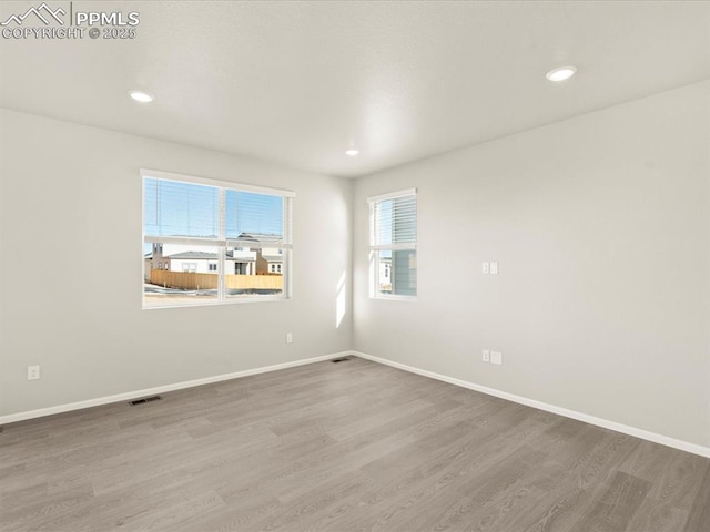 unfurnished room with hardwood / wood-style floors