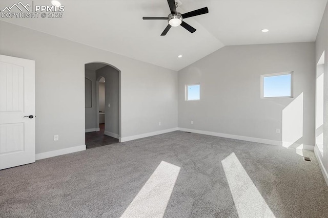 empty room featuring ceiling fan, carpet flooring, and vaulted ceiling