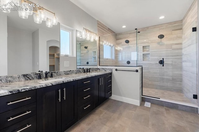 bathroom featuring vanity and a tile shower