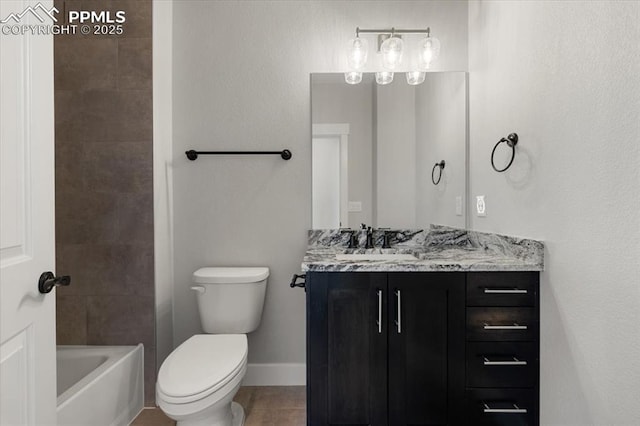 full bathroom with vanity, tiled shower / bath, and toilet