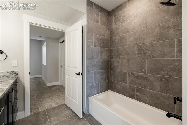 bathroom featuring tile patterned floors, vanity, and tiled shower / bath combo