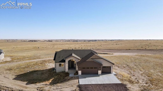 view of front of house with a rural view and a garage