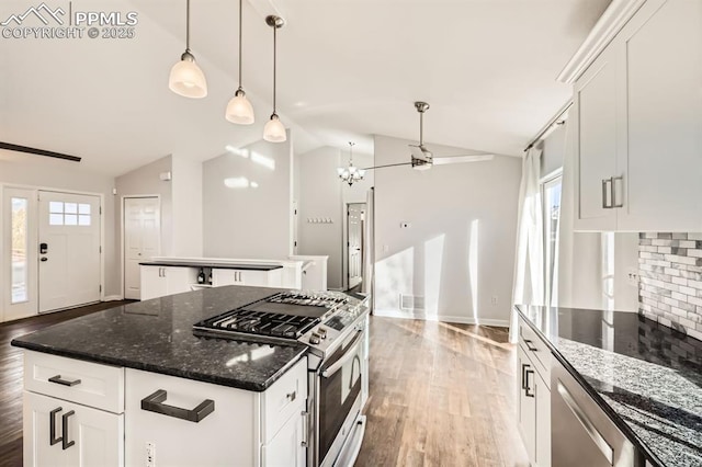 kitchen featuring white cabinetry, lofted ceiling, appliances with stainless steel finishes, and a kitchen island