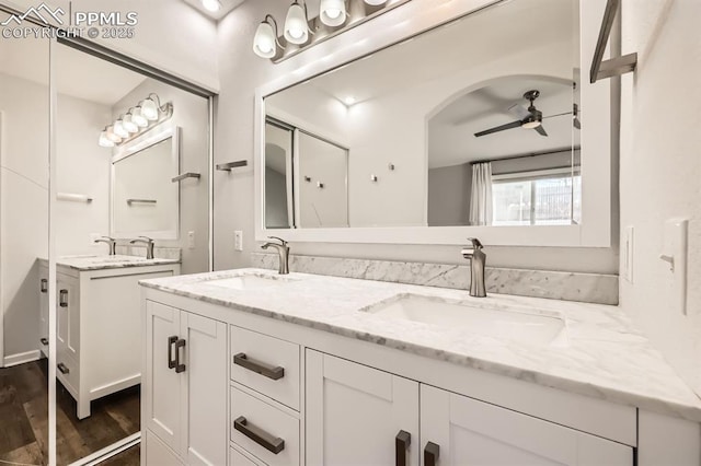 bathroom with ceiling fan, vanity, and wood-type flooring