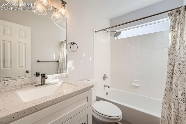 full bathroom with vanity, shower / bath combo, and toilet