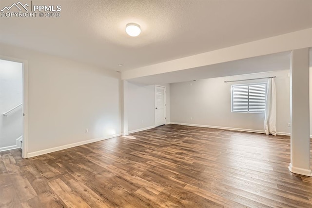 spare room with hardwood / wood-style flooring and a textured ceiling