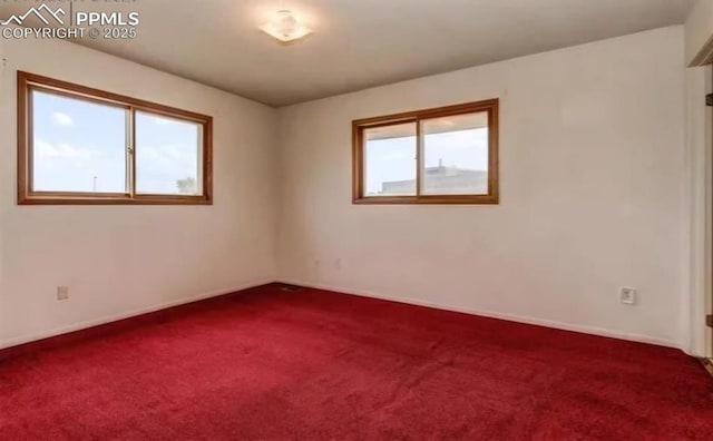 carpeted empty room with a wealth of natural light