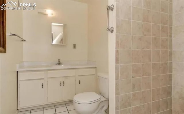 bathroom featuring tile patterned flooring, vanity, and toilet