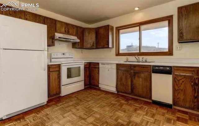 kitchen featuring white appliances, sink, and light parquet flooring