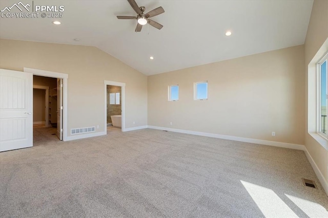 unfurnished bedroom with vaulted ceiling, light carpet, ceiling fan, and ensuite bathroom