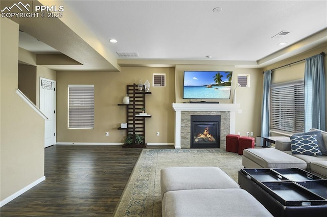 living room with dark hardwood / wood-style floors and a fireplace