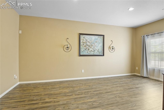 unfurnished room with dark wood-type flooring