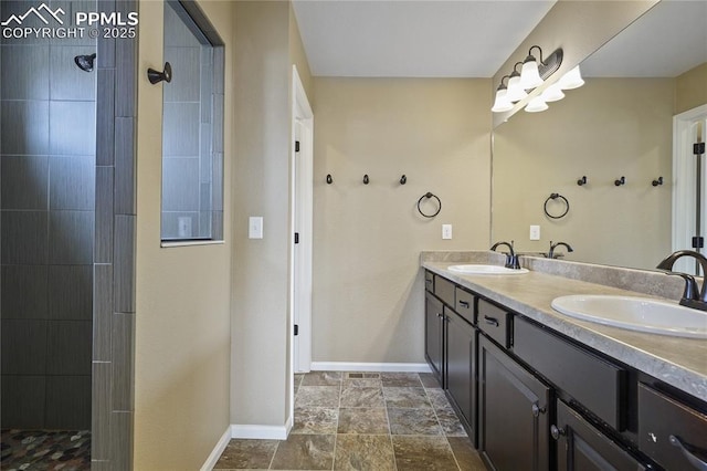 bathroom featuring tiled shower and vanity