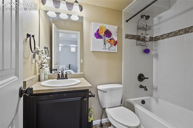 full bathroom featuring tiled shower / bath combo, vanity, and toilet