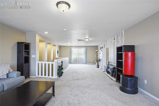 carpeted living room featuring a textured ceiling