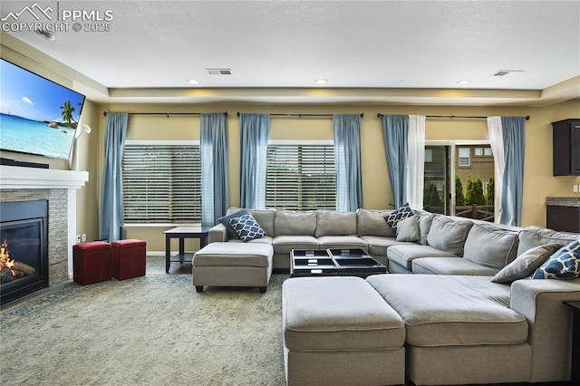 carpeted living room featuring a fireplace