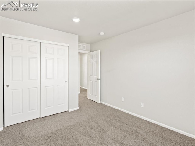 unfurnished bedroom with carpet and a closet